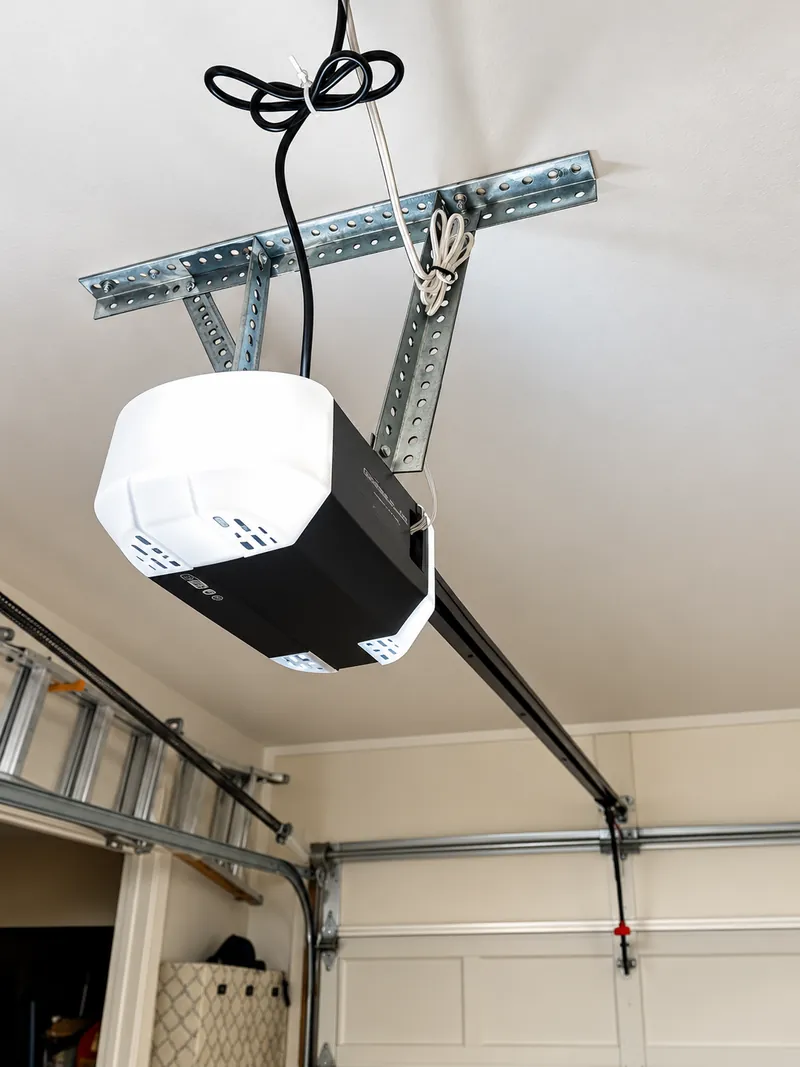 Residential garage door opener motor and ceiling rail system